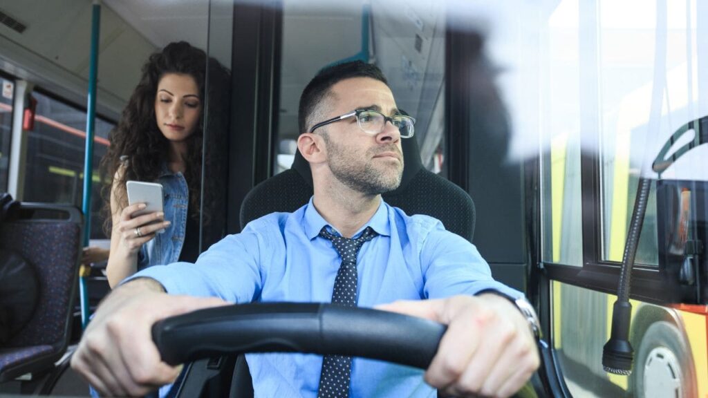 Motorista de onibus coletivo Consciente e Respeitoso e passageira ao fundo mechendo no celular